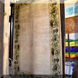 R97. Wool rug with grapevine border.